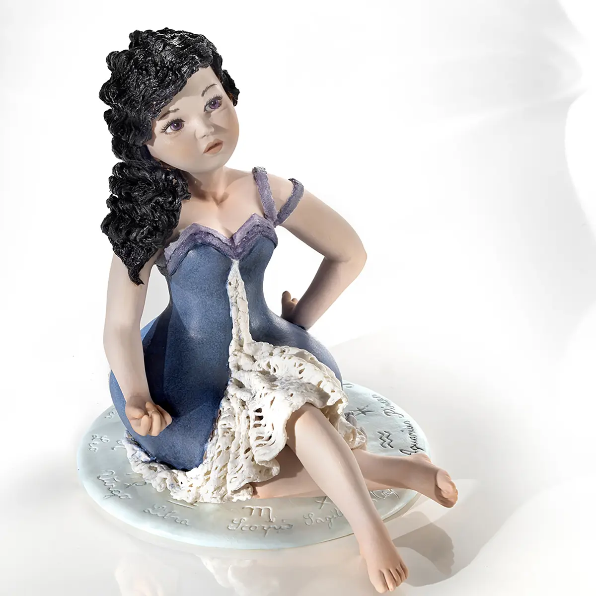 Statua in porcellana Sibania del segno Acquario in abito blu e indaco con trina arricciata e capelli neri.