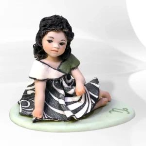 Statua in porcellana mini Capricorno Sibania in abito verde scuro e nero con busto proteso in avanti e base verde.