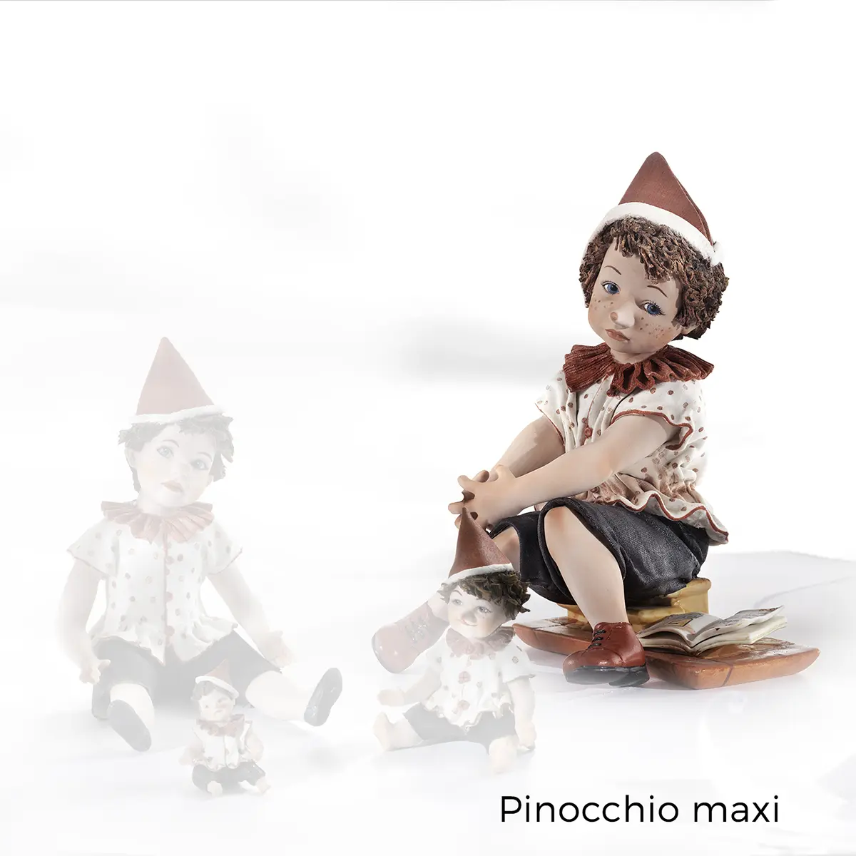 Statua in porcellana di Pinocchio Maxi seduto su uno scalino giallo, con casacca a pois rossi e cappello a barchetta.