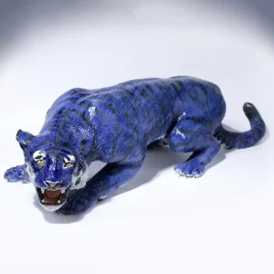 Statua in porcellana di tigre azzurra con un ordinato intreccio geometrico di ciuffi triangolari.